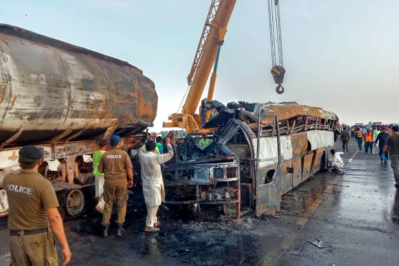 At least 20 killed when bus crashes into fuel truck