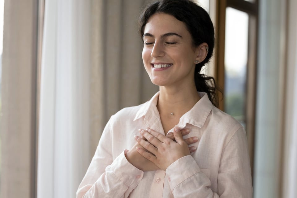 Young woman being grateful, thank you, mindfulness