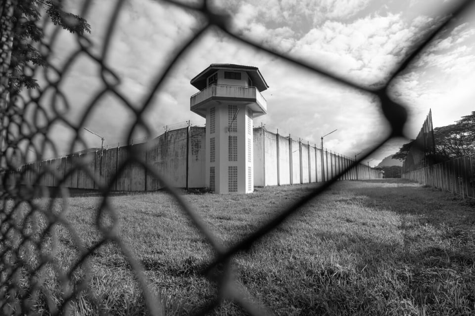 A prison seeing through a gate in black and white