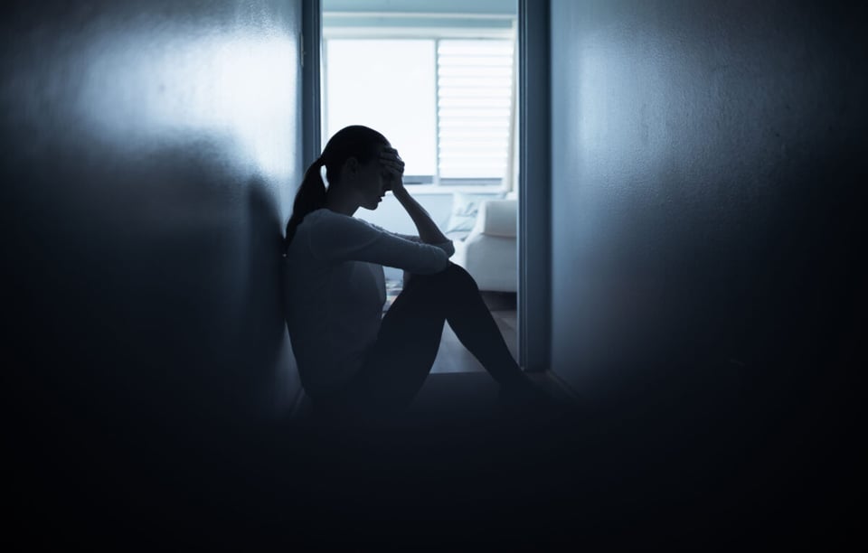 Woman sit on floor sad