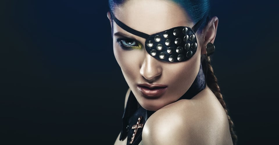 A woman with an eye patch impersonating a soap opera villain