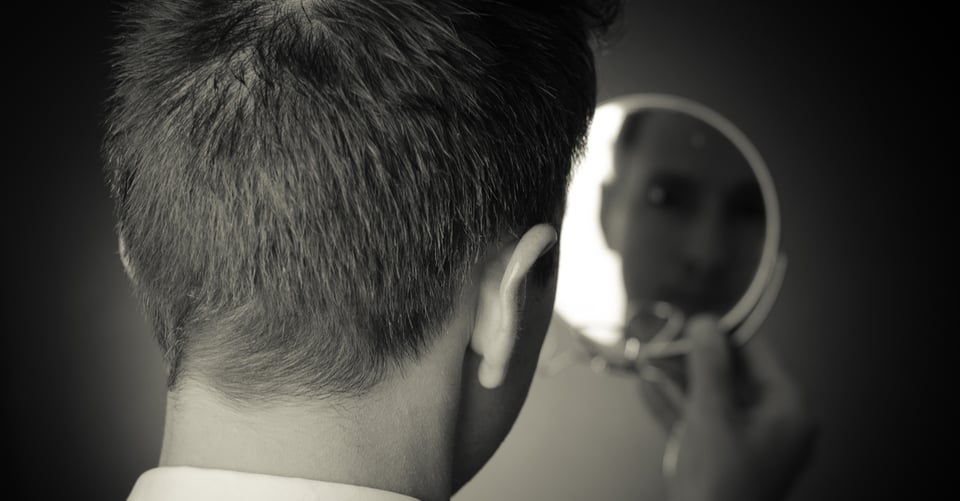 Man looking in the mirror