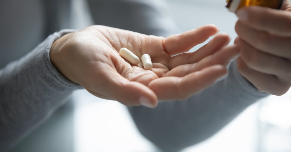 Person with capsules that may be for the flu