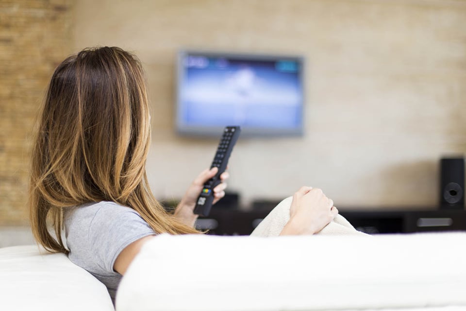 Young woman watching TV, news, information